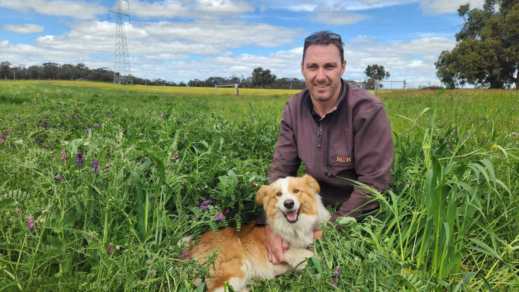 Jamie Anderson with his dog, on his farm in Williams