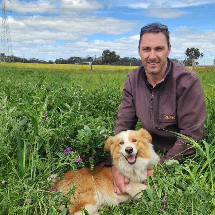 Jamie Anderson with his dog, on his farm in Williams