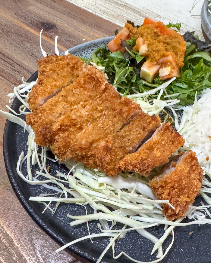 Tonkatsu meal with pork, cabbage, rice and salad