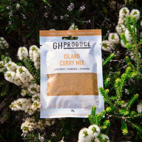 GH Produce Island Curry Mix packet surrounded by greenery and white flowers