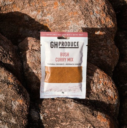 Packaged bush curry mix on a rocky surface